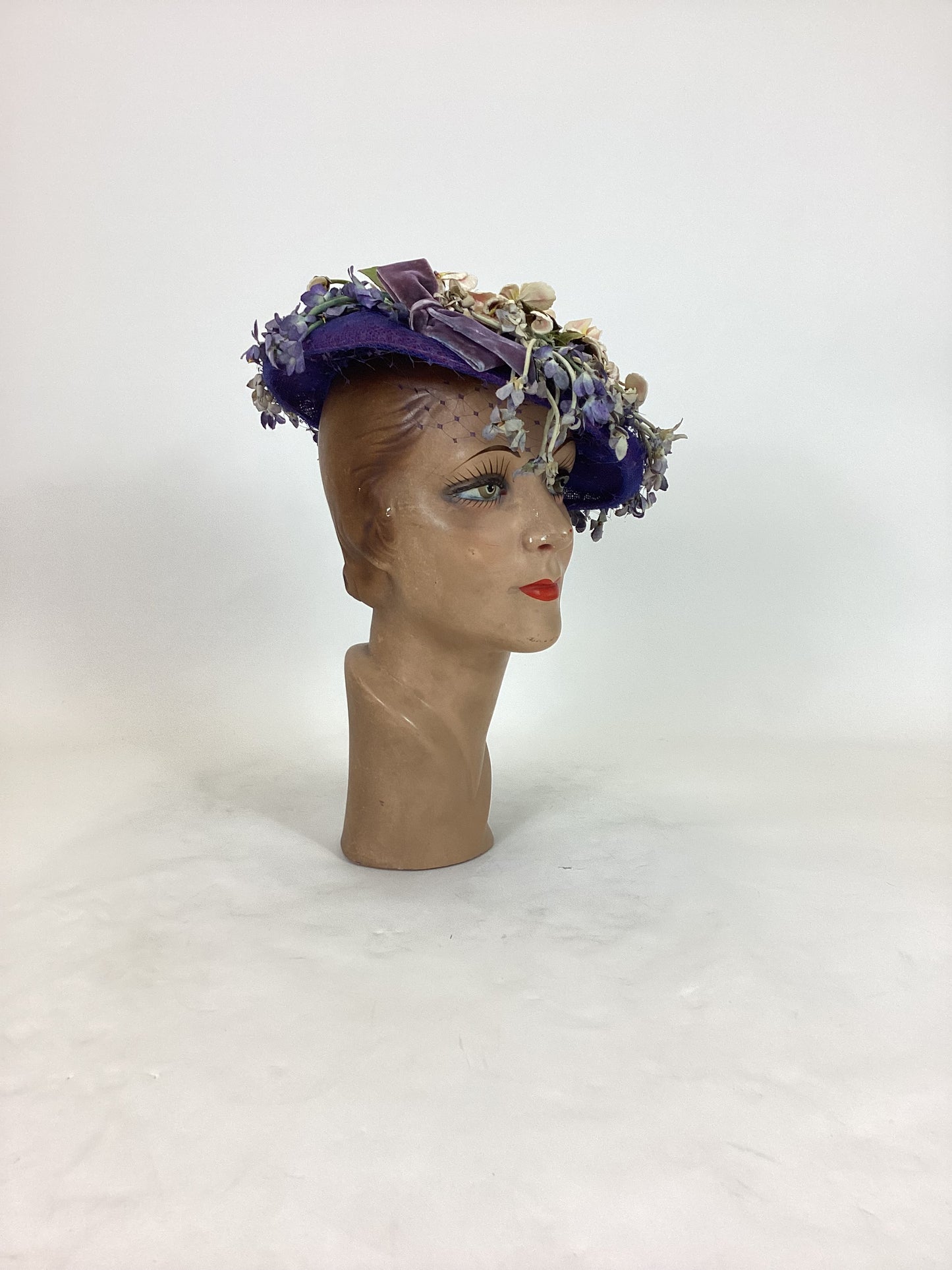 Original 1940’s Striking Platter Hat - A true Cadbury Purple, adorned with mixed flowers.